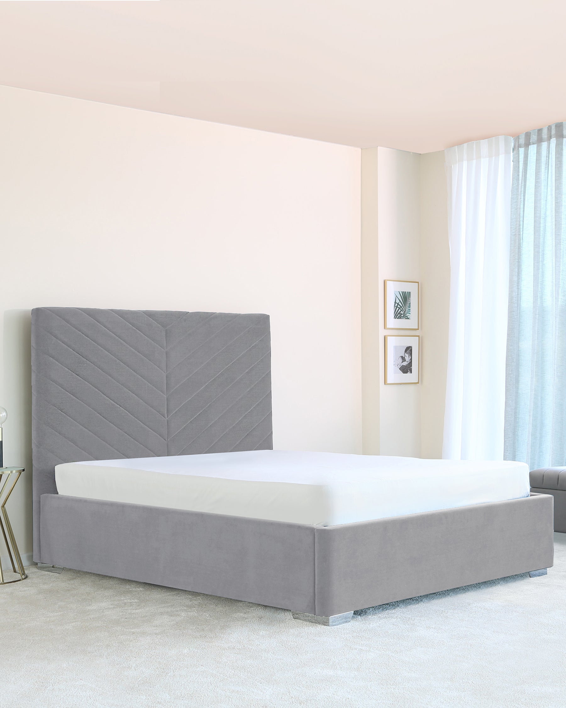 Modern grey upholstered king-size platform bed with an elegantly tufted headboard in a chevron pattern displayed in a minimalist bedroom setting.