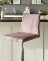 Modern backless bar stool with dusty rose velvet upholstery and a sleek chrome pedestal base.