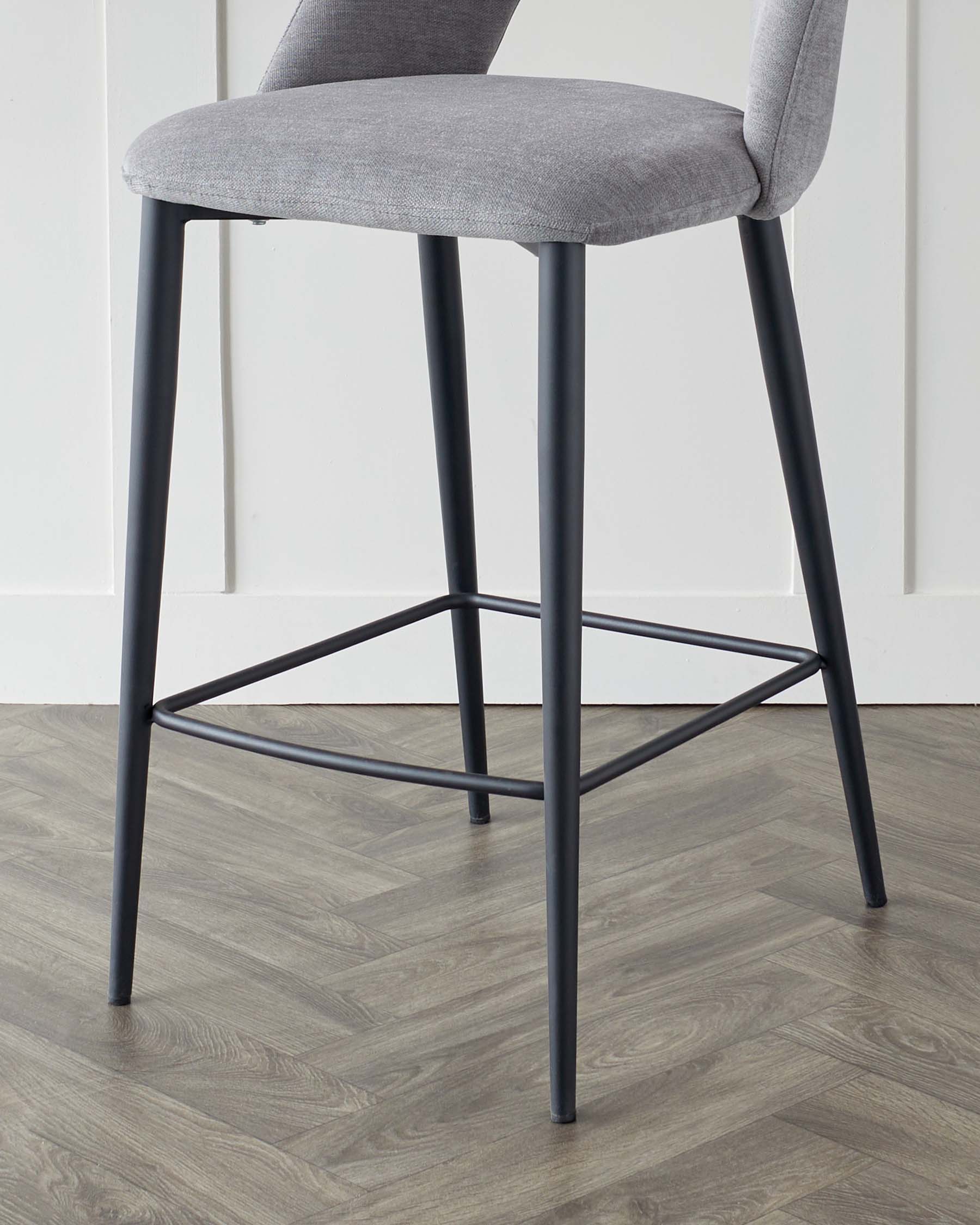 Modern bar stool with sleek metal legs in matte black finish and light grey upholstered seat and backrest.