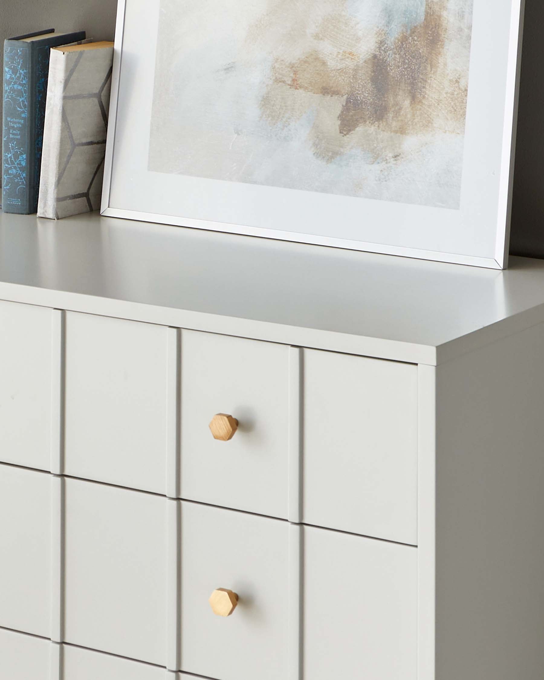 Modern white dresser with clean lines and natural wooden knobs.