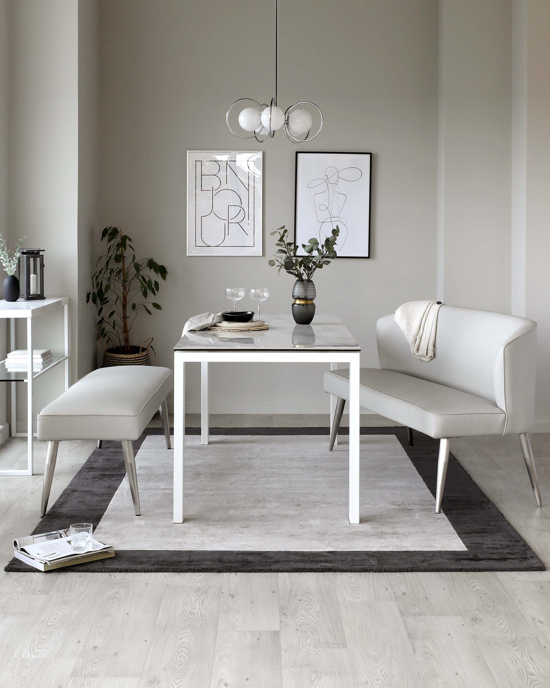 Contemporary dining set with a white rectangular table accompanied by a matching bench and two minimalist chairs in an off-white tone, set on a two-tone grey area rug. A sleek sideboard with a white top and minimalistic square legs is visible to the left, accessorized with modest decor.