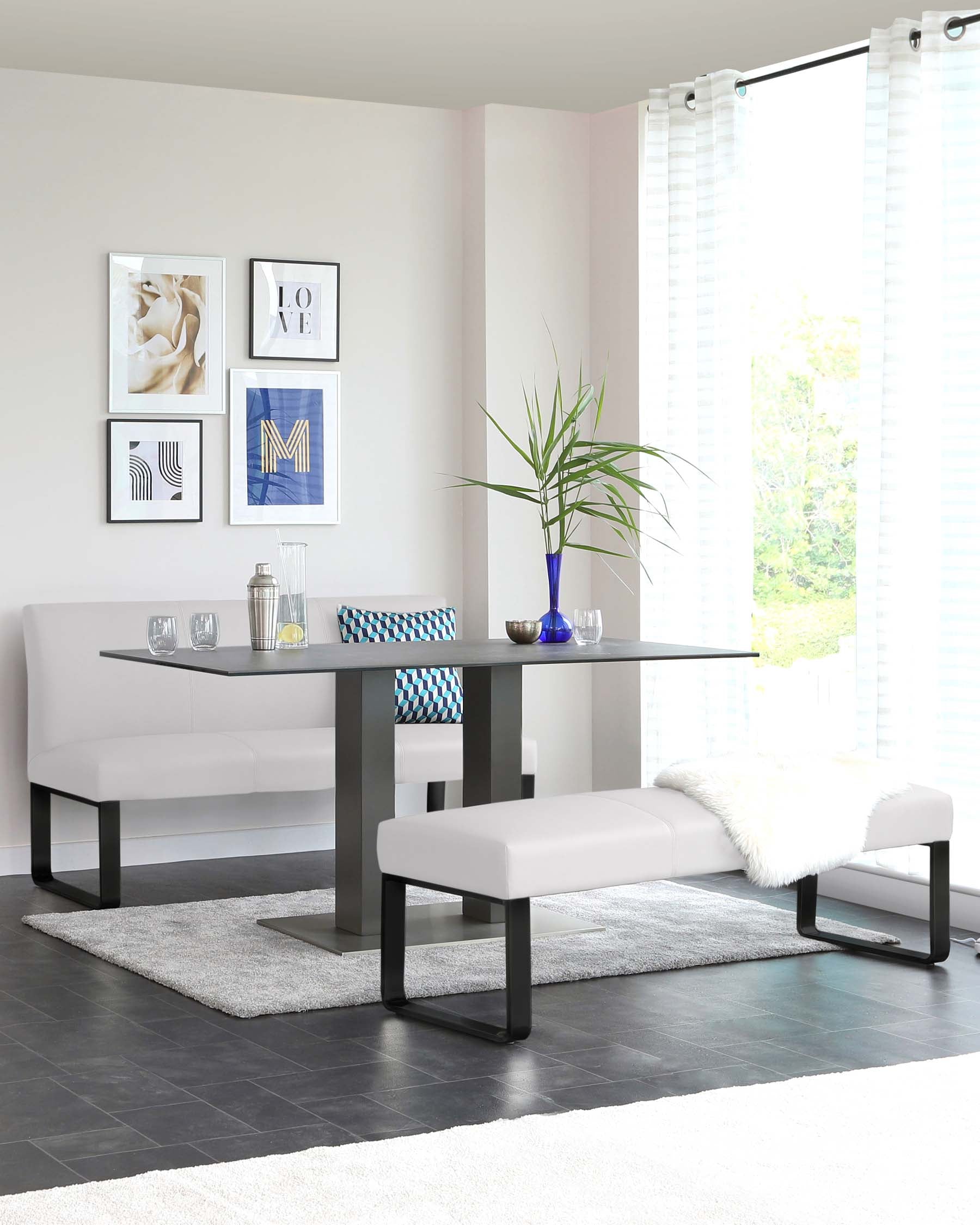 Modern dining furniture setup featuring a sleek, rectangular table with a glossy finish and metal legs. Accompanied by a matching bench with cushioned seating and one end with a decorative faux fur throw. The space is complemented by a plush, grey area rug beneath the set.