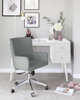 Modern home office setup featuring a sleek white desk with a minimalist design, straight lines, and two drawers, paired with a stylish grey upholstered office chair with a high back, armrests, and a chrome five-star base with casters.