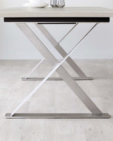 Modern dining table with a sleek light wood top and an eye-catching stainless steel X-shaped base. Minimalist and stylish design.