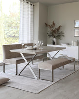 Modern dining set featuring a sleek table with metal legs, paired with plush benches, on a soft area rug by a window.