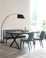 A modern dining set featuring a quilted bench, two matching chairs, and a sleek table, complemented by an arc floor lamp.