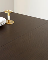 Elegant dark wood dining table with a fine-grained finish and a minimalist design.