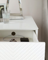 Modern white nightstand with an open shelf and smooth tabletop, featuring clean lines and minimalist design.