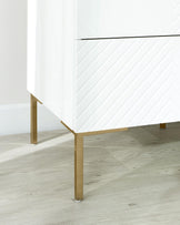 Modern minimalist white dresser with chevron design and sleek gold legs.