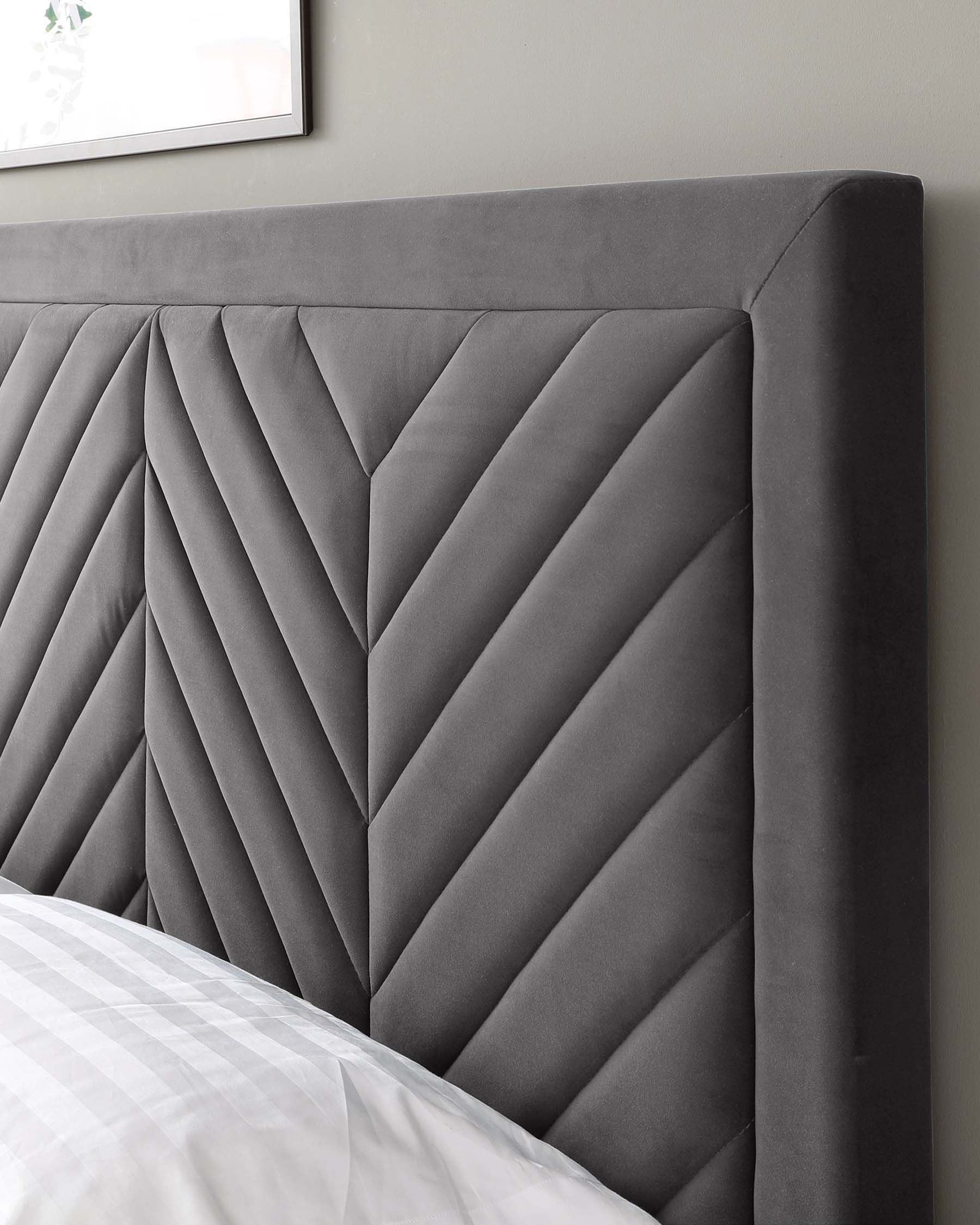 Elegant grey upholstered headboard featuring a sophisticated herringbone pattern with deep tufting, providing a modern and luxurious focal point for a contemporary bedroom setting.