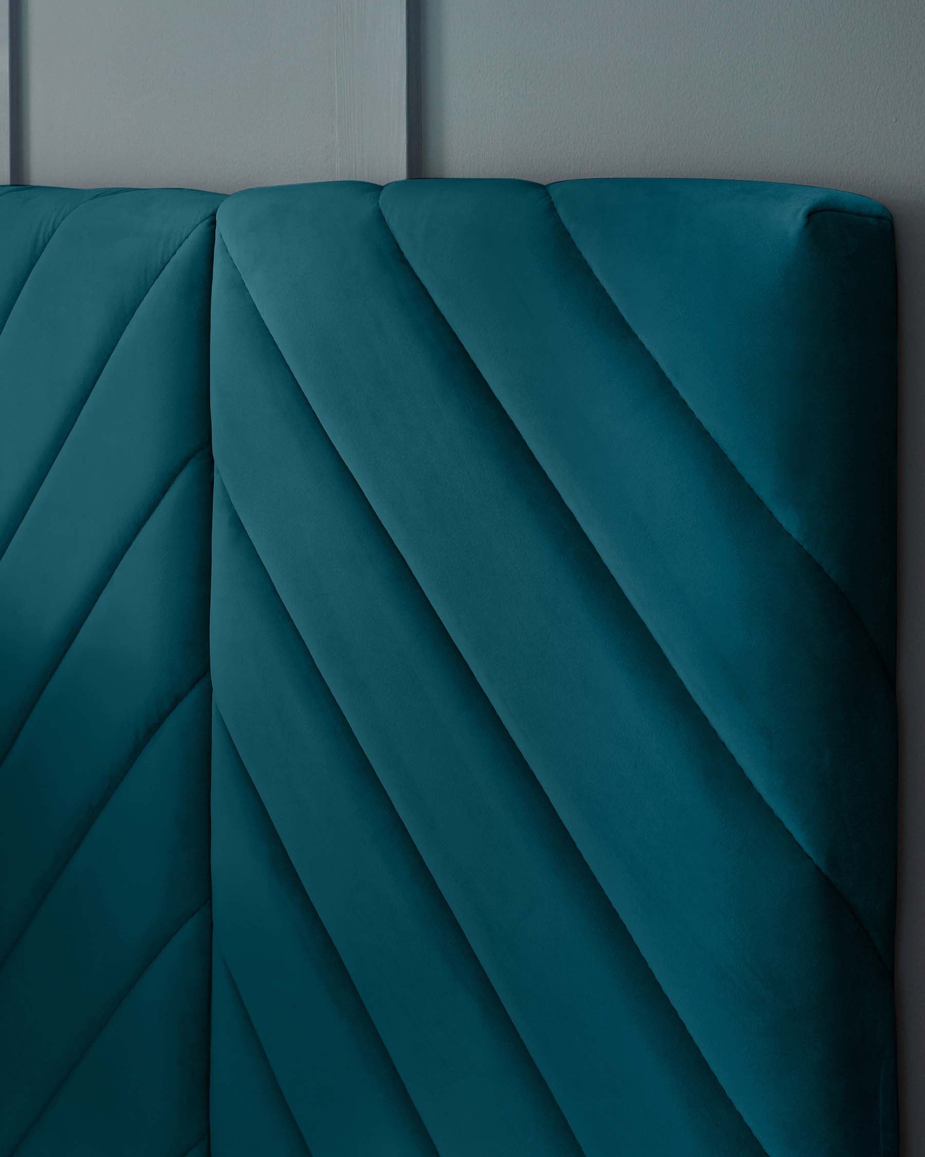 Elegant teal upholstered headboard with a sophisticated vertical channel tufted design.