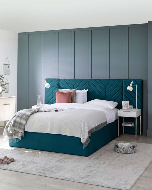 Stylish teal upholstered bed with a tufted headboard, white bedding, modern nightstand, and decorative accents in a chic setting.