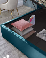 Deep teal modern bench with a glossy finish, fitted with soft grey and blush pillows, situated on a light wood floor, partially under a black grand piano, showcasing elegance and contemporary design.