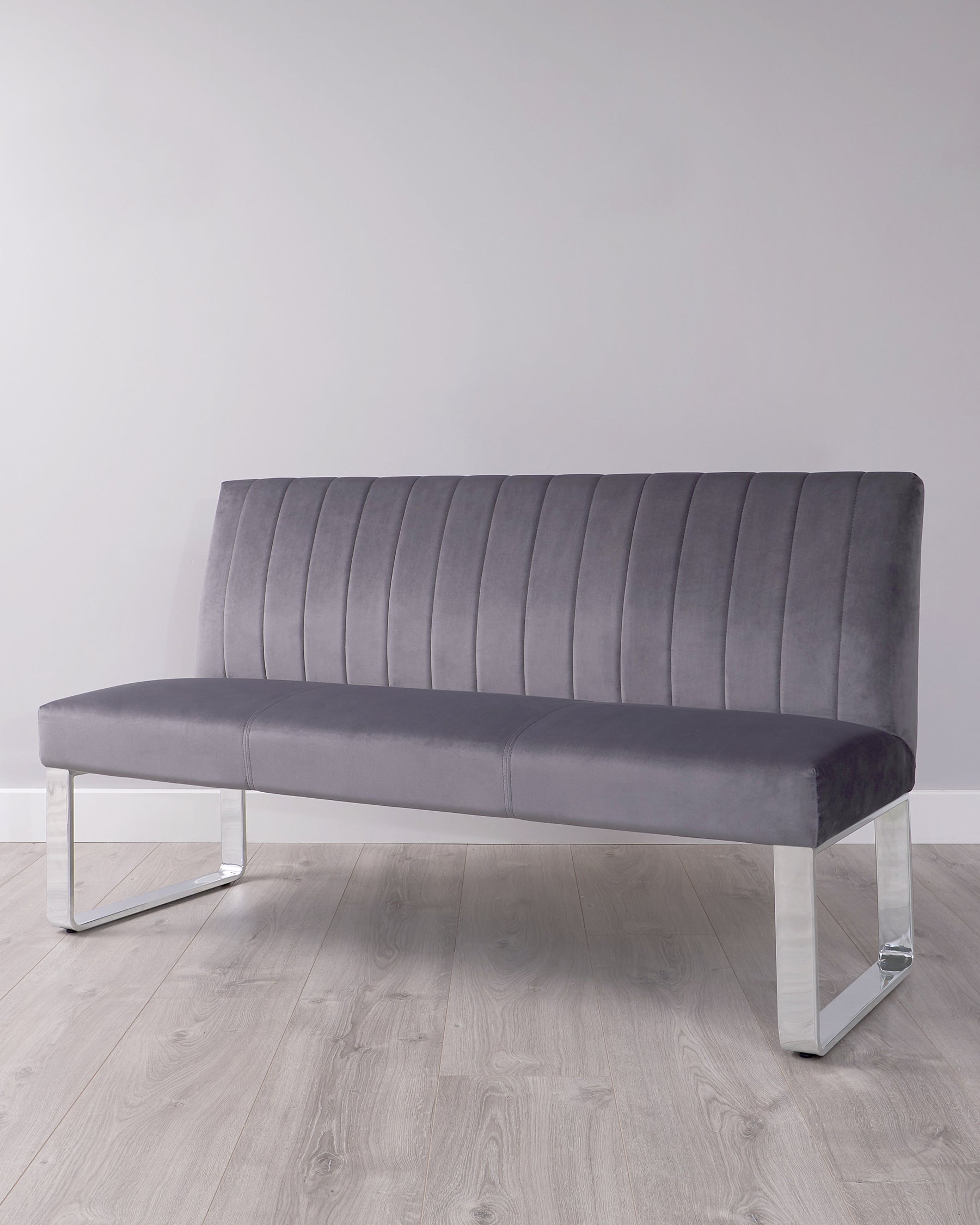 A sleek gray velvet bench with vertical stitching and modern chrome legs, perfect for contemporary interiors.