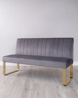 Stylish grey velvet bench with vertical ribbing and sleek gold metal legs, perfect for modern decor.