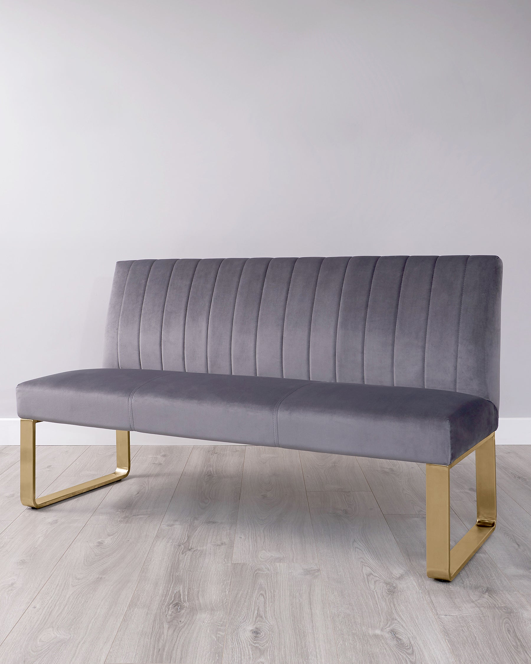 Stylish grey velvet bench with vertical ribbing and sleek gold metal legs, perfect for modern decor.