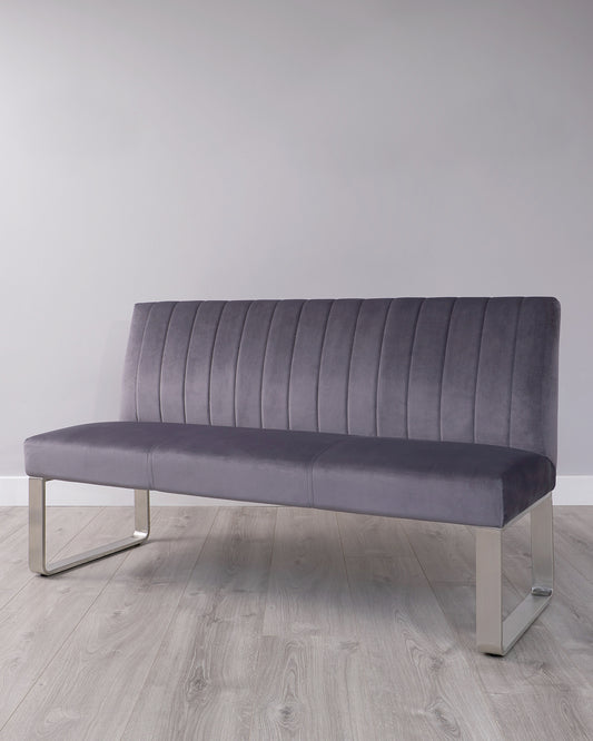 Modern grey upholstered bench with vertical channel tufting and sleek metallic legs.