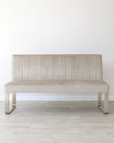 Elegant beige velvet bench with horizontal stitching and sleek metal legs, perfect for modern interiors.