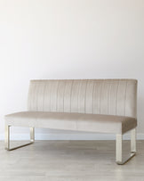 Elegant beige velvet bench with vertical stitching and sleek metal legs, ideal for modern interiors.