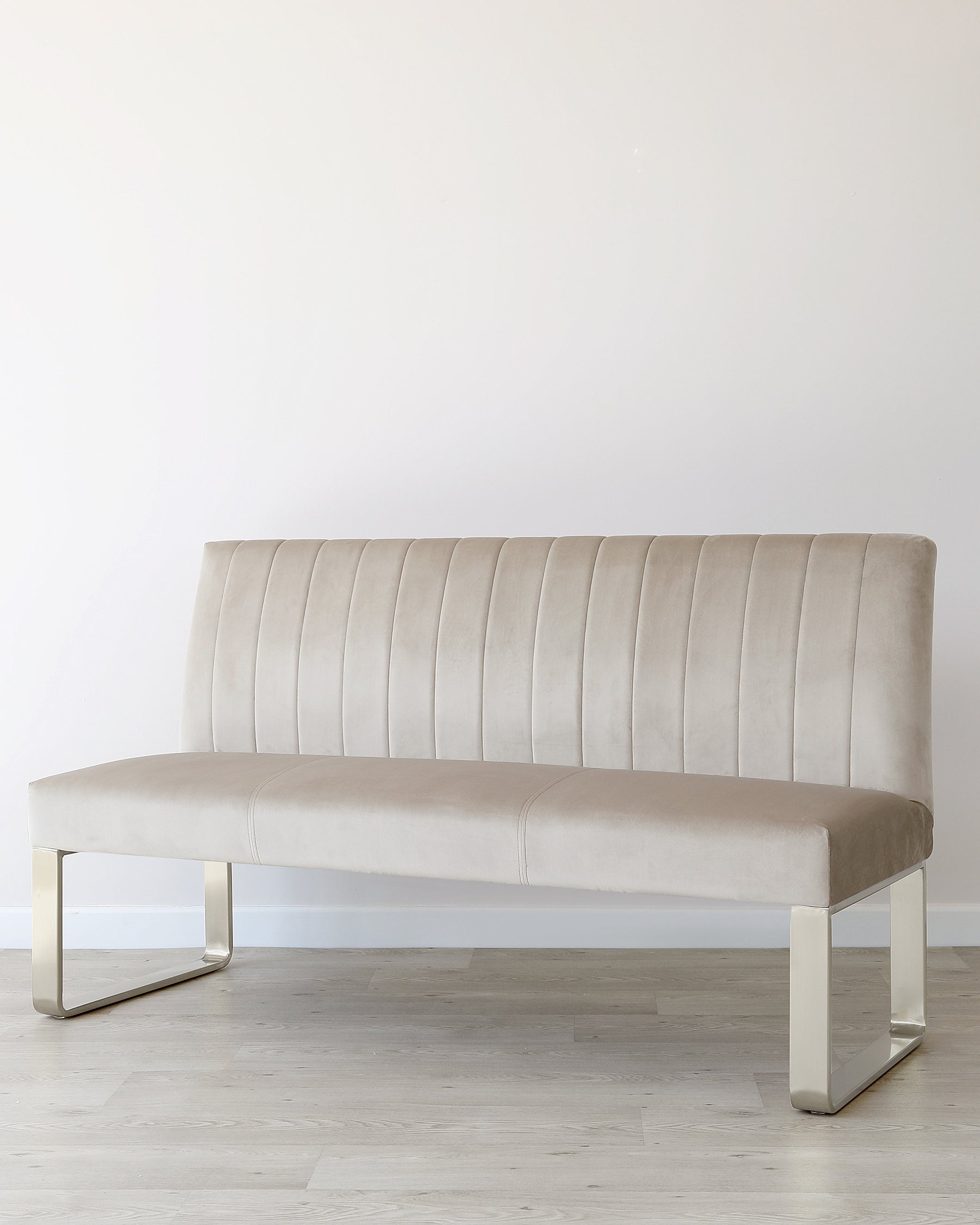 Elegant beige velvet bench with vertical stitching and sleek metal legs, ideal for modern interiors.