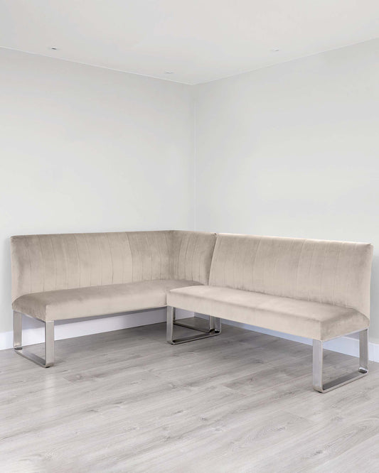 Modern L-shaped sectional bench with a plush, tufted velvet fabric in a neutral beige tone, featuring a clean-lined design supported by sleek, chrome-finished metal legs.