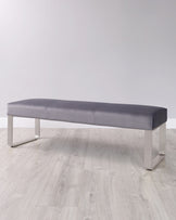 Modern gray upholstered bench with sleek metallic legs, ideal for minimalist decor and versatile seating solutions.