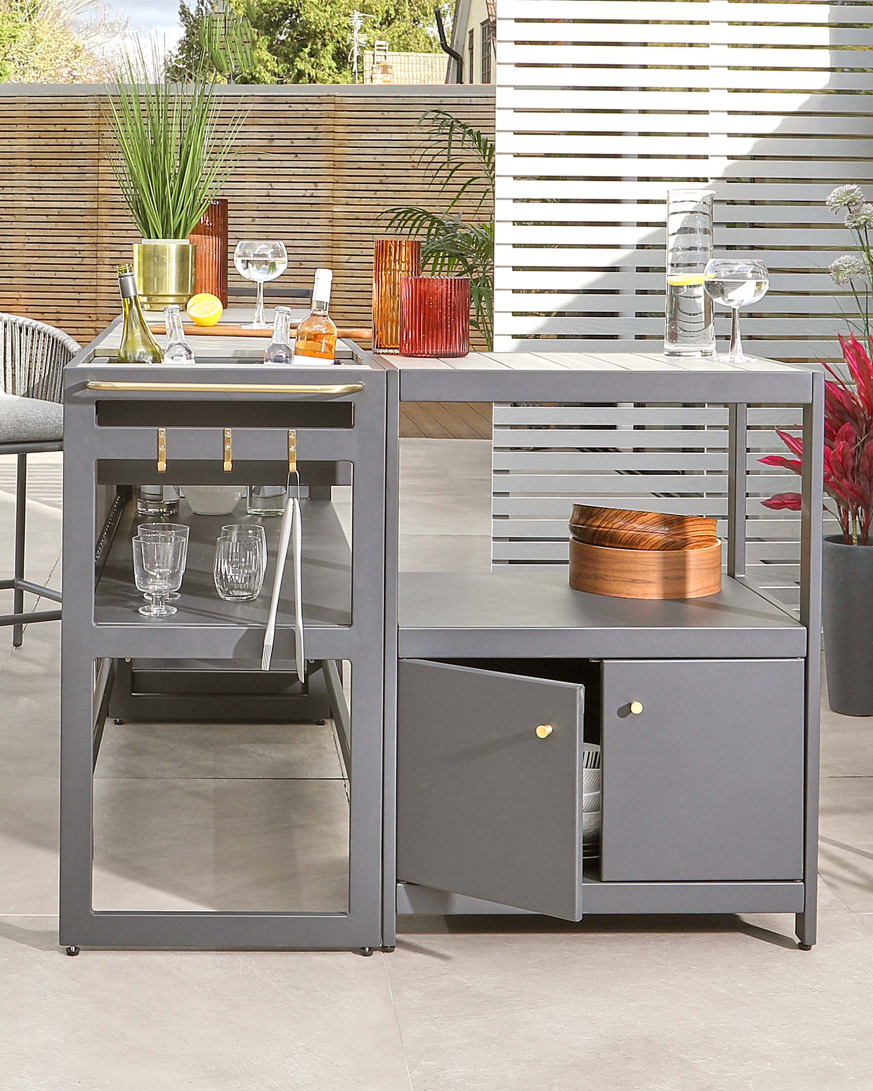 Modern gray outdoor bar cart with shelves, drink storage, and decorative accessories, perfect for entertaining.