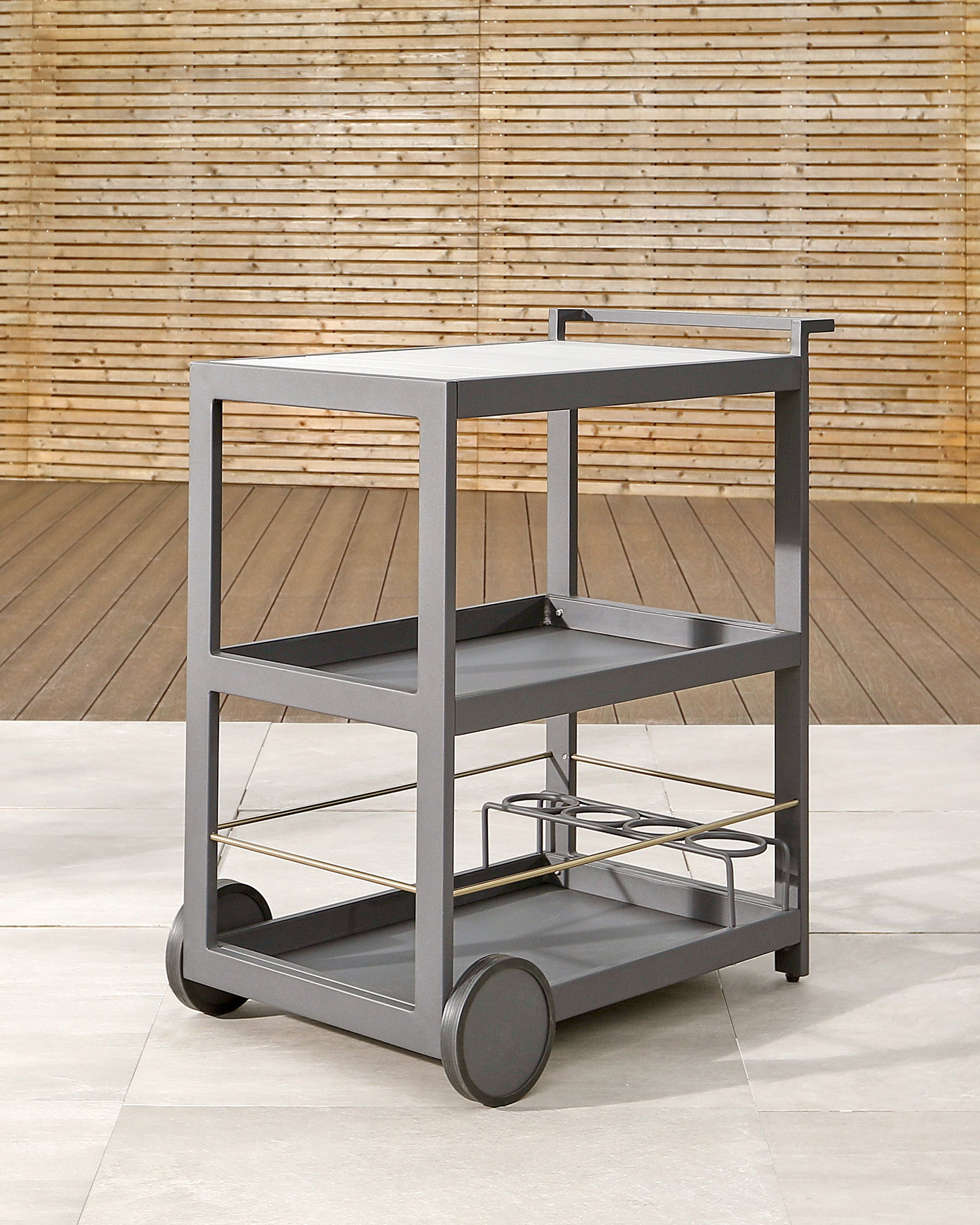 Modern three-tiered metal bar cart on wheels with bottle holders, featuring a matte grey finish and minimalist design.