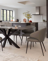 A contemporary dining set featuring a rectangular table with a dark finish and a striking X-base design. Accompanying the table are four sleek, upholstered dining chairs in a muted taupe tone, each with a curved backrest and angular legs that echo the table's modern aesthetic.