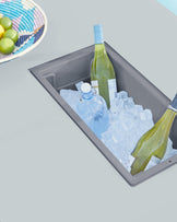 Modern outdoor furniture featuring a built-in ice bucket compartment, with clean lines and a minimalist grey design.