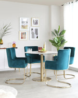 Modern dining room featuring a round white marble tabletop with a central gold pedestal base, surrounded by four plush teal velvet chairs with sleek gold metal legs forming a unique cantilever design. The chairs have high backs and armrests for comfortable seating. The elegant colour palette provides a chic and luxurious aesthetic for contemporary interiors.