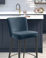 Elegant navy blue velvet bar stool with a high backrest and matte black metal legs, featuring a comfortable padded seat and a sleek, contemporary design suitable for modern kitchen interiors.