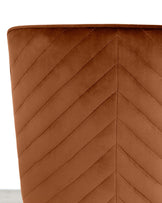 Close-up of a modern burnt orange upholstered furniture piece featuring a chevron pattern with stitched detailing.