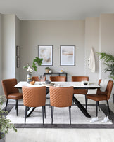 A contemporary dining room featuring a rectangular white tabletop with black angled legs, surrounded by four caramel-coloured leather chairs with quilted backrests and black metal legs. A matching caramel-coloured leather bench with a quilted design completes the set on one side of the table. The room is accented with minimalist décor, including wall art, a table runner, and simple tableware, creating an elegant and inviting space.