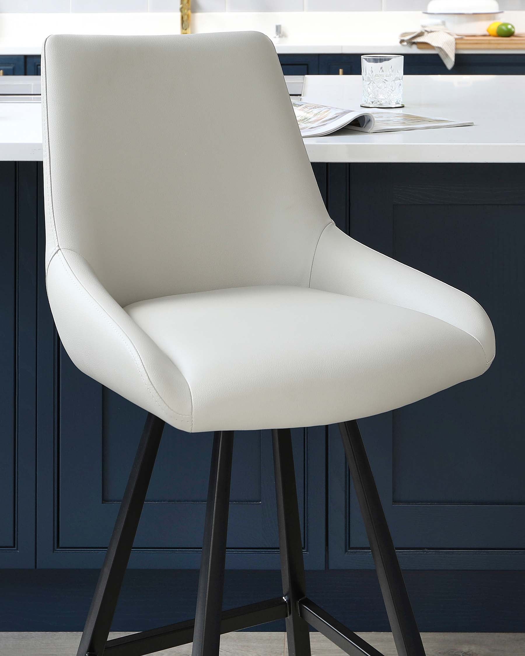 Modern counter-height stool with a sleek design, featuring a comfortable, curved backrest and a padded seat in an elegant light cream upholstery. The stool rests on a sturdy four-legged metal base in a contrasting dark finish, offering stability and a sophisticated look perfect for contemporary kitchen or dining spaces.