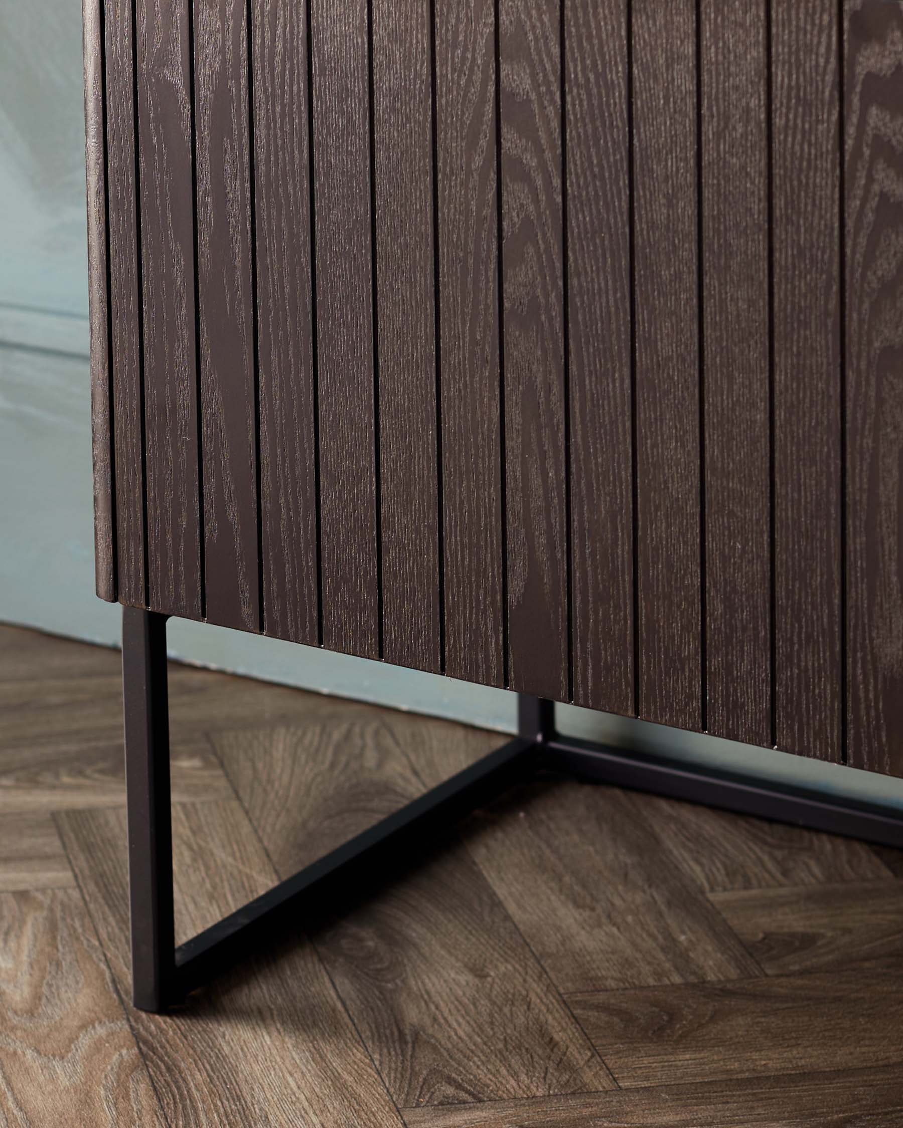 Stylish dark wood sideboard with vertical slats and a sleek metal frame, perfect for contemporary interiors.