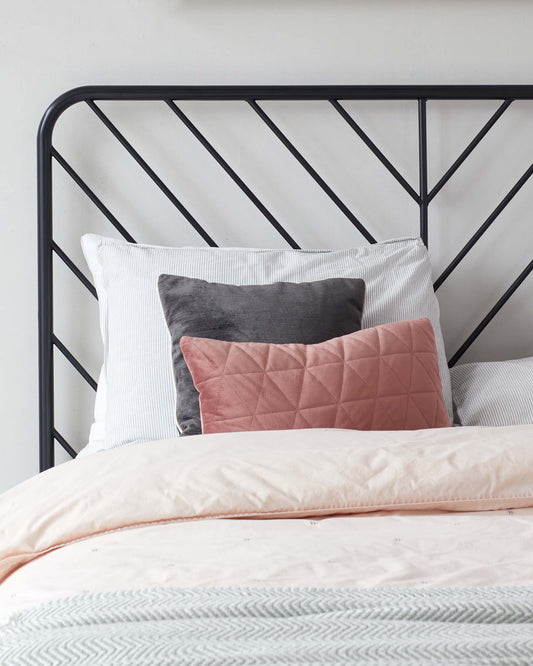 A contemporary metal bed frame with a minimalist geometric headboard design. The frame is finished in matte black, featuring straight lines and angular details that create a simple yet stylish aesthetic.